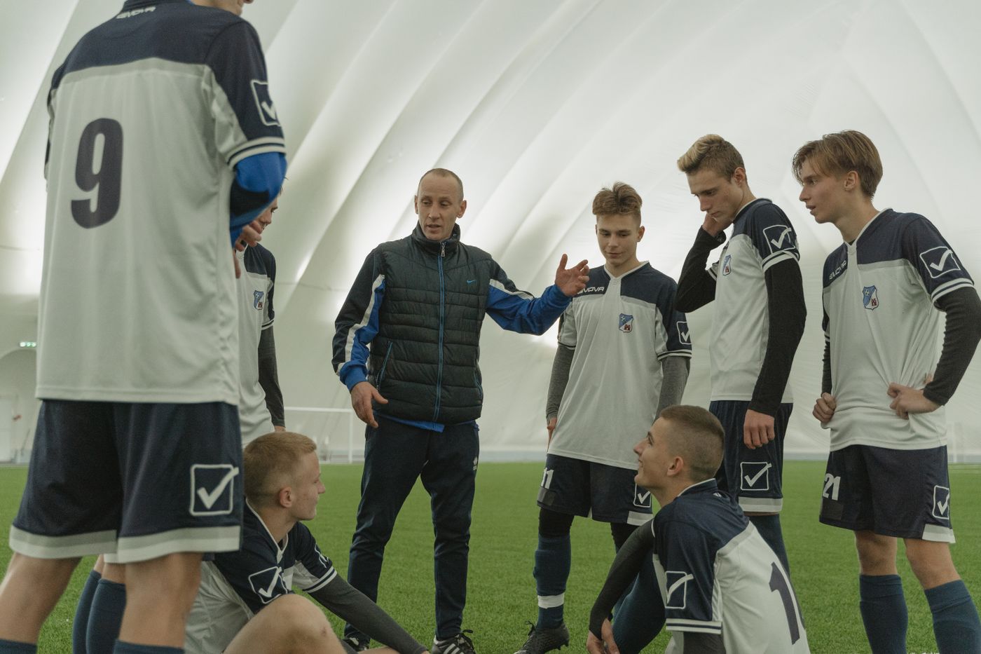 Coach sharing experience with the team